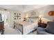 Cozy bedroom with a ceiling fan, carpet and wrought iron bed frame complemented by decorative wall art at 311 Garvin St # 301B, Punta Gorda, FL 33950