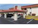 Covered carport provides assigned parking, with a red tile roof and attractive landscaping at 311 Garvin St # 301B, Punta Gorda, FL 33950