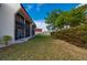 Beautiful lawn and manicured hedges surrounding condo with screened lanai, offering privacy and tranquil outdoor space at 311 Garvin St # 301B, Punta Gorda, FL 33950