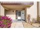 Inviting front entrance features an open white front door, blooming bougainvillea and stone landscaping at 311 Garvin St # 301B, Punta Gorda, FL 33950