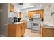 Functional kitchen with white appliances, wooden cabinetry and ample counter space for meal preparation at 311 Garvin St # 301B, Punta Gorda, FL 33950