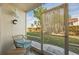 Charming lanai area with wicker furniture and a view of the lush greenery outside at 311 Garvin St # 301B, Punta Gorda, FL 33950
