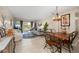 Open-concept living space features a dining area, comfortable seating, and access to outdoor patio at 311 Garvin St # 301B, Punta Gorda, FL 33950