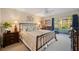 Inviting main bedroom with an iron bed frame, a ceiling fan, and sliding doors to the lanai at 311 Garvin St # 301B, Punta Gorda, FL 33950