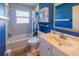 Bathroom featuring blue walls, shower, and vanity at 3270 Ithaca St, Port Charlotte, FL 33952