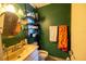 Compact bathroom featuring green walls, a corner shower, a sink, a toilet, and towel rack at 3270 Ithaca St, Port Charlotte, FL 33952