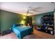 Bedroom featuring dark green walls, carpet floors, ceiling fan, and ample storage, offering a comfortable space at 3270 Ithaca St, Port Charlotte, FL 33952
