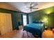 Bedroom with dark green walls, carpet floors, a ceiling fan, closet, and natural light from a window at 3270 Ithaca St, Port Charlotte, FL 33952