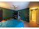 Bedroom featuring dark green walls, a ceiling fan, storage, and a view to a bathroom at 3270 Ithaca St, Port Charlotte, FL 33952