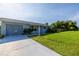 Well-maintained home with an attached garage, front yard and long driveway at 3270 Ithaca St, Port Charlotte, FL 33952