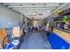 Cluttered garage space with storage solutions, a bicycle, work area, and ample room for parking at 3270 Ithaca St, Port Charlotte, FL 33952