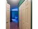 Hallway leading to a bedroom with a blue accent wall, showcasing the home's layout and design at 3270 Ithaca St, Port Charlotte, FL 33952