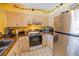 Kitchen with stainless steel appliances, tile flooring, and wood cabinets at 3270 Ithaca St, Port Charlotte, FL 33952
