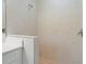 Modern shower featuring stone-look tiling and stone pebble floor at 339 Canora Dr, Port Charlotte, FL 33954