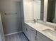 Double vanity bathroom with dual sinks, granite countertops and white shaker cabinets at 3532 Richardson St, North Port, FL 34288