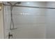 Bathroom with sleek, shiny white subway tile surround and brushed nickel shower fixtures at 3532 Richardson St, North Port, FL 34288