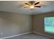 This bedroom features ceiling fan and a large window with natural light and modern wood-look flooring at 3532 Richardson St, North Port, FL 34288