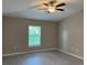 Spacious bedroom featuring a ceiling fan, a window with natural light and modern wood-look flooring at 3532 Richardson St, North Port, FL 34288