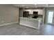 Open-concept kitchen and living area with a center island and stainless steel appliances, all illuminated by recessed lighting at 3532 Richardson St, North Port, FL 34288