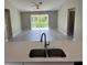 Open-concept kitchen featuring a breakfast bar with a sink and modern faucet at 3532 Richardson St, North Port, FL 34288