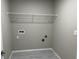 Compact laundry room featuring modern hookups, shelf, and neutral paint at 3532 Richardson St, North Port, FL 34288