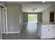 Open-concept living space with light gray walls and modern wood-look flooring at 3532 Richardson St, North Port, FL 34288