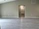 Spacious living room with grey wood-look flooring, and neutral paint colors at 3532 Richardson St, North Port, FL 34288