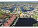Aerial view of a waterfront home with a private dock, set in a charming neighborhood at 3588 Tripoli Blvd, Punta Gorda, FL 33950