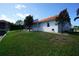 Backyard view of the property, showcasing the outdoor space and part of the red tile roof at 3588 Tripoli Blvd, Punta Gorda, FL 33950