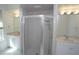 Bathroom featuring double vanities, a glass-enclosed shower, and white tiled floors at 3588 Tripoli Blvd, Punta Gorda, FL 33950