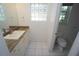 Well-lit bathroom featuring a granite countertop vanity and a view into the toilet and bathtub area at 3588 Tripoli Blvd, Punta Gorda, FL 33950