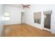 Comfortable primary bedroom featuring hardwood floors, a ceiling fan and sliding doors leading to the outside at 3588 Tripoli Blvd, Punta Gorda, FL 33950