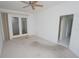 Spacious bedroom with carpet, ceiling fan, and access to an outdoor balcony at 3588 Tripoli Blvd, Punta Gorda, FL 33950