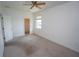 Bedroom with neutral carpet, ceiling fan, walk-in closet and window at 3588 Tripoli Blvd, Punta Gorda, FL 33950