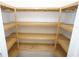 Walk-in closet with custom-built wooden shelving provides efficient storage solutions at 3588 Tripoli Blvd, Punta Gorda, FL 33950