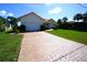 Charming single-story home with red tile roof and brick paved driveway leading to an attached garage at 3588 Tripoli Blvd, Punta Gorda, FL 33950