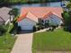 Beautiful waterfront home featuring a red tile roof, attached garage, and lush landscaping at 3588 Tripoli Blvd, Punta Gorda, FL 33950