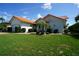 Well-maintained single-story home featuring a red tile roof, lush lawn, and mature landscaping at 3588 Tripoli Blvd, Punta Gorda, FL 33950