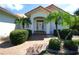 Welcoming front entrance with a brick pathway, decorative plants, and a covered entryway at 3588 Tripoli Blvd, Punta Gorda, FL 33950