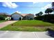 Inviting single-story home with a red tile roof, manicured lawn, and charming curb appeal at 3588 Tripoli Blvd, Punta Gorda, FL 33950
