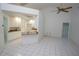 Spacious kitchen featuring white cabinets, granite counters, and tiled floors adjacent to a large living space at 3588 Tripoli Blvd, Punta Gorda, FL 33950