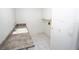 Practical laundry room features ample counter space, upper cabinets, and tile flooring at 3588 Tripoli Blvd, Punta Gorda, FL 33950