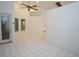 Inviting living room featuring tile flooring, a ceiling fan and glass doors leading to the outside at 3588 Tripoli Blvd, Punta Gorda, FL 33950