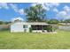 Spacious backyard featuring lawn and covered patio; ideal for outdoor activities and relaxation at 3612 Patina Dr, Tampa, FL 33619