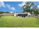 Backyard featuring a covered, screened patio area and well-maintained lawn at 3612 Patina Dr, Tampa, FL 33619