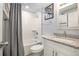 Bright bathroom featuring a shower-tub combo, granite counters, and a decorative mirror at 3612 Patina Dr, Tampa, FL 33619