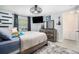 Bright bedroom with a playful decor, stylish floating shelves, and a unique ceiling fan, a cozy haven at 3612 Patina Dr, Tampa, FL 33619