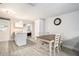 Bright dining area adjacent to the kitchen, featuring modern lighting and a view into another room at 3612 Patina Dr, Tampa, FL 33619