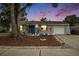 Charming single-story home with a well-manicured front yard and a blue front door at 3612 Patina Dr, Tampa, FL 33619