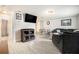Cozy living room with a large sectional couch, entertainment center, and open access to the dining area at 3612 Patina Dr, Tampa, FL 33619